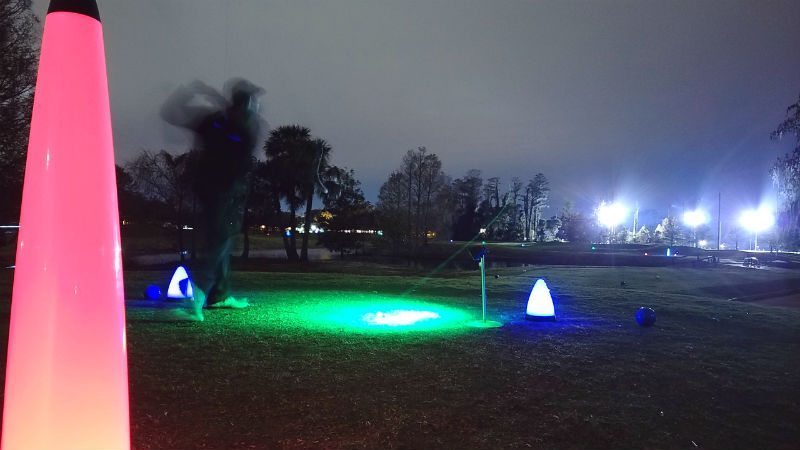 playing glow golf at night